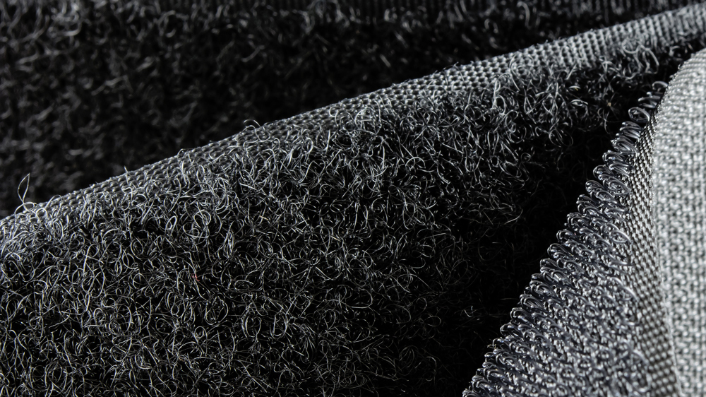 Hook and loop fasteners are woven textiles with their own tolerances.